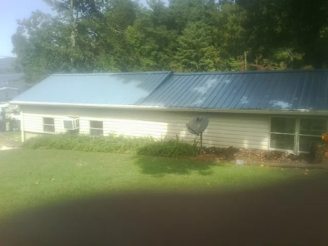Blue metal roof running the length of a single story home in Williamsburg